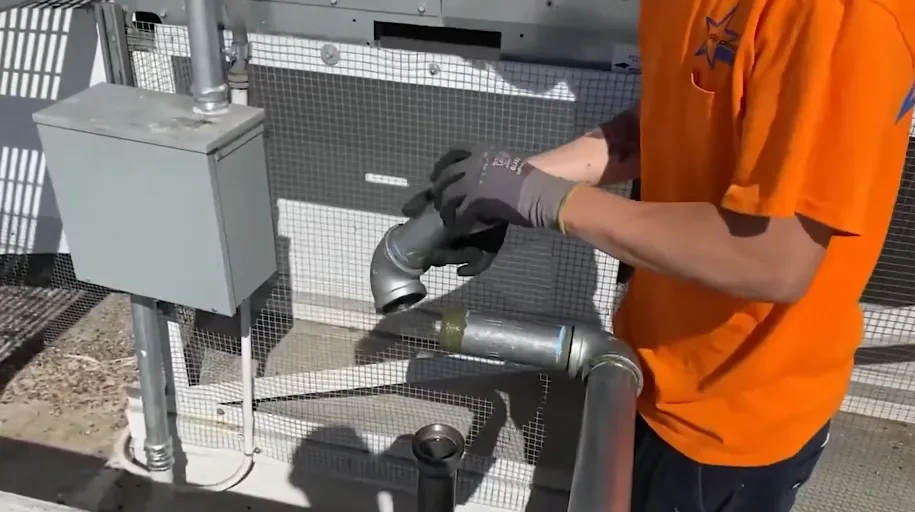 Plumber working on gas piping beside a gas meter