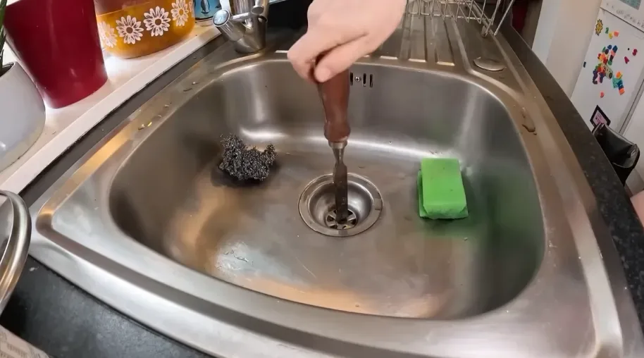 Clearing a clogged stainless steel kitchen sink drain